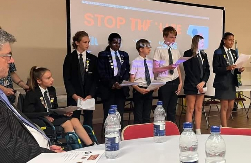Mr Safet Vukalic watches Woodlands School pupils give a presentation at the "Stop the Hate" Event.
