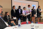 Mr Safet Vukalic watches Woodlands School pupils give a presentation at the "Stop the Hate" Event.
